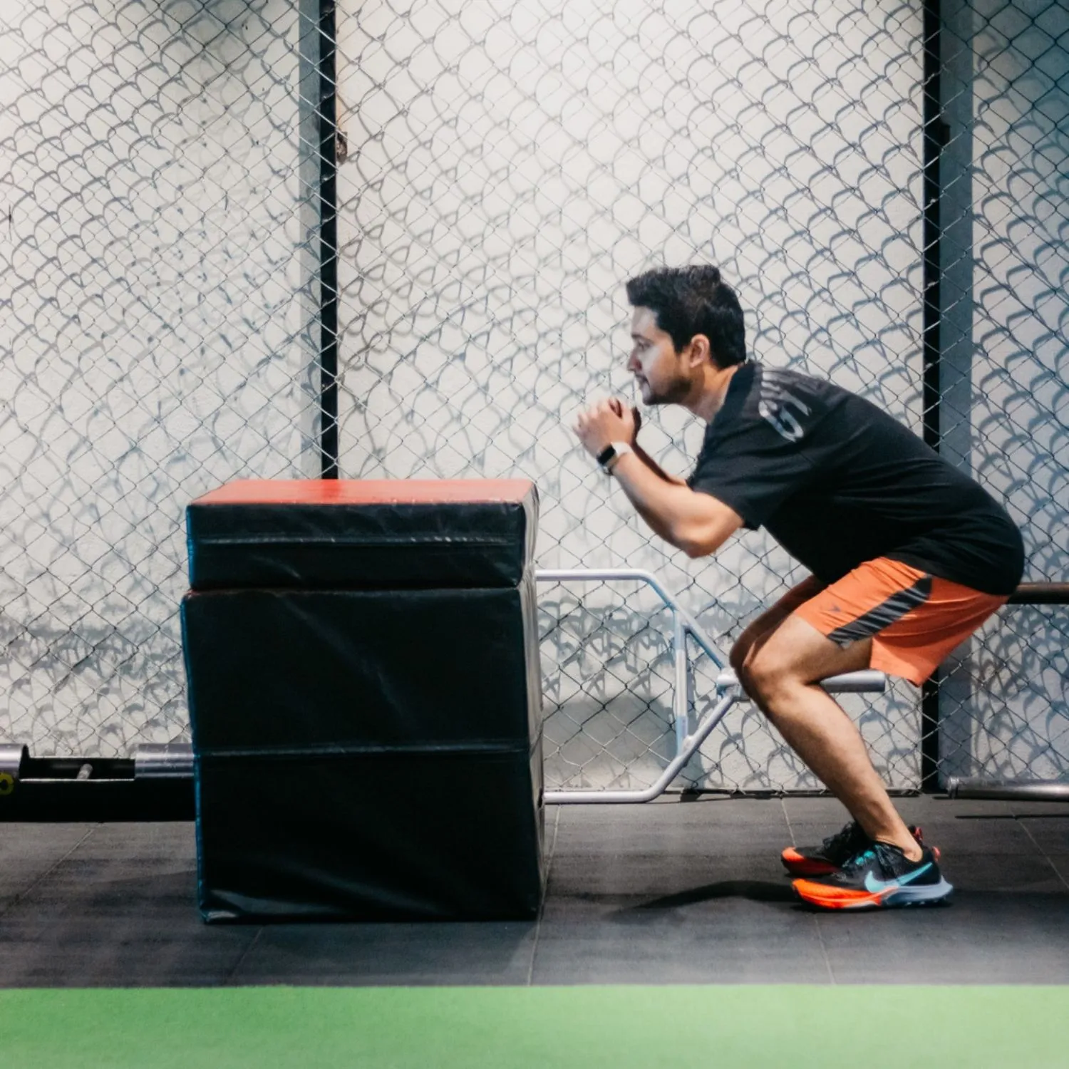 Coach cueing a box squat