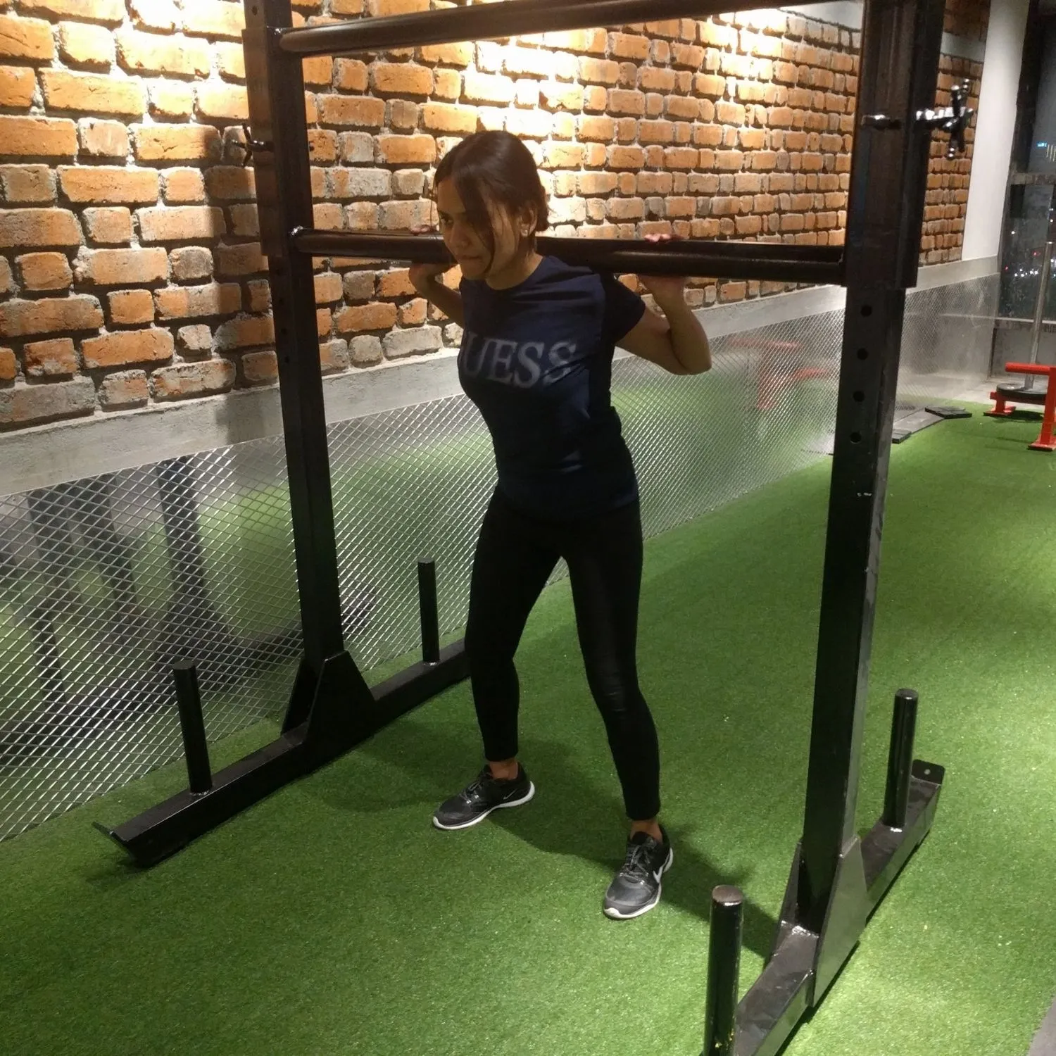 Carrying a loaded barbell across the turf